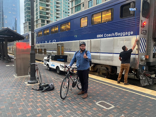 Fabian Campos with a bike at an Amtrak train station.